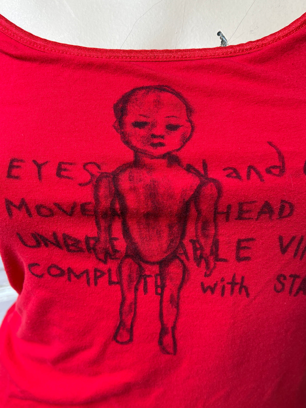 Doll Features Red Tank